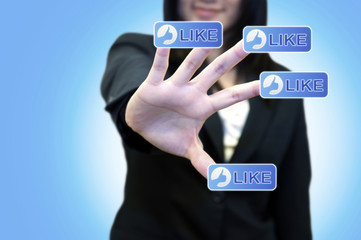Business woman with hand touching LIKE button on touch screen
