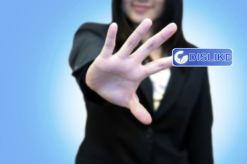 Business woman with hand touching DISLIKE button on touch screen