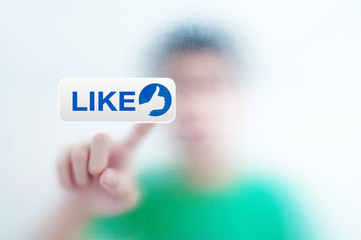 man pressing a touchscreen like button