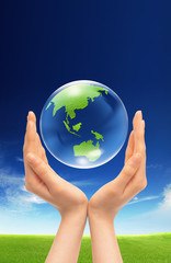 Hands and Earth. Symbol of environmental protection