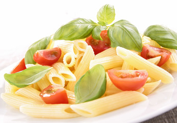 cooked pasta with tomato and basil