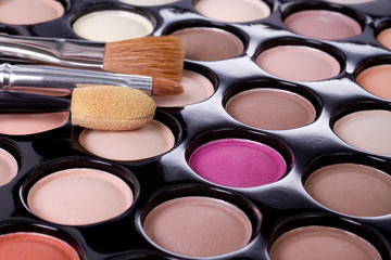 make-up colorful eyeshadow palette with brushes closeup