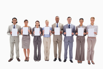 Obraz premium Business people holding white support for letters