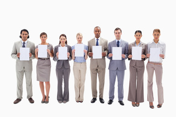 Fototapeta premium Serious business people holding support for letters