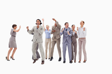 Obraz premium Very happy business people jumping and clenching their fists