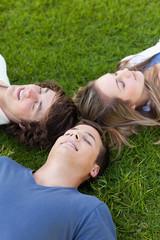 Three students lying together