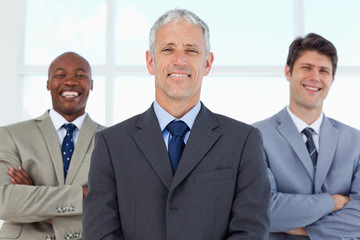 Fototapeta premium Two young employees standing in the back while laughing and bein