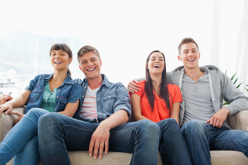 Fototapeta premium A group of laughing friends look into the camera