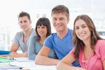 Side view of four students looking towards the camera