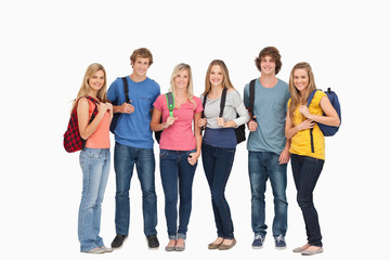 Fototapeta premium Smiling group with backpacks on as they smile
