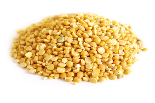Pile dry split yellow peas isolated on white background