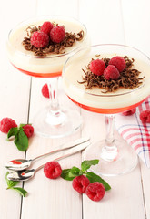 fruit jelly with berries in glasses on wooden table