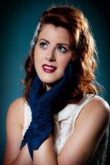 Fototapeta premium Beautiful retro young female in blue gloves and dress