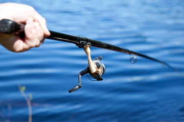 Hand holding fishing rod