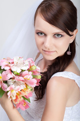 Obraz na płótnie Canvas Beautiful bride in wedding dress in studio shooting