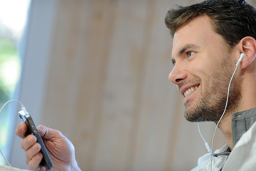 Young man listening to music on smartphone