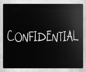 The word "Confidential" handwritten with white chalk on a blackb