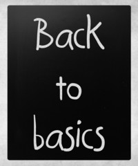 "Back to basics" handwritten with white chalk on a blackboard