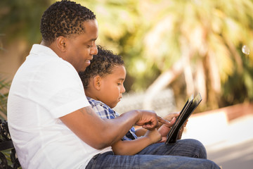 Mixed Race Father and Son Using Touch Pad Computer Tablet