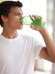 Stock image of a teenager drinking water