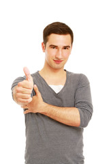A smiling man showing thumb up sign