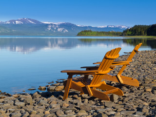 Wooden deckchairs overlooking scenic Lake Laberge