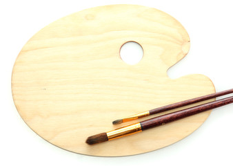 wooden art palette and brushes isolated on white