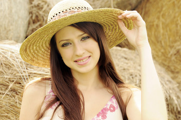 Portrait of beautiful young woman in sun hat