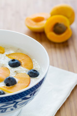 oatmeal porridge with fresh berries and apricots