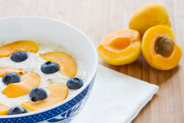 oatmeal porridge with fresh berries and apricots