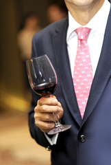 glass of red wine on hand