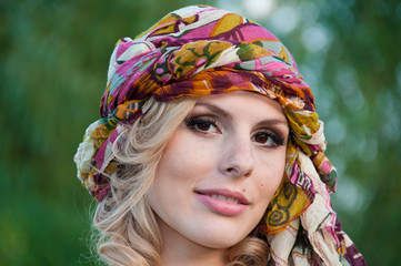 A large portrait of a pretty girl in a turban