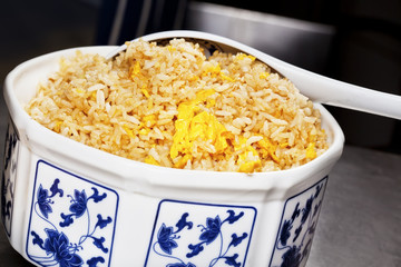 Chinese egg fried rice in traditional porcelain bowl.