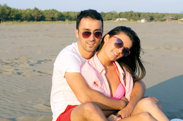 Happy couple at the beach in a playful mood