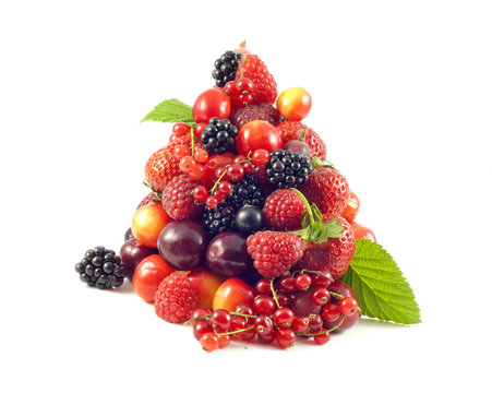 pile of fresh berries and fruit on white background