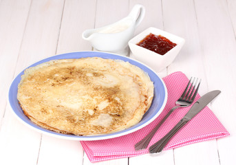 Stack of tasty pancakes on wooden background