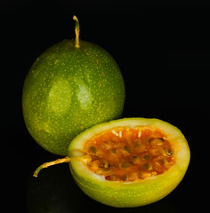 green passion fruit isolated on black background