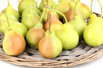 ripe pears on wicker mat isolated on white.