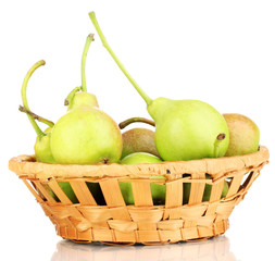 ripe pears in basket isolated on white.