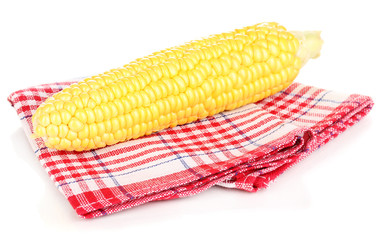 Fresh corn cob on napkin isolated on white