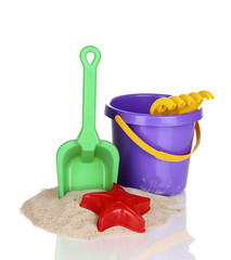 Children's beach toys and sand isolated on white