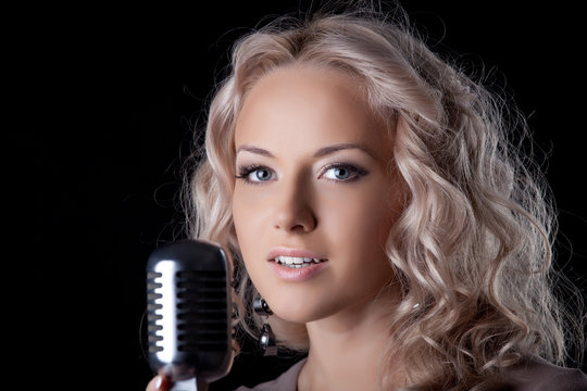 Beautiful young woman with microphone