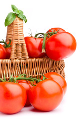 Wicker basket full of delicious tomatoes