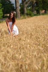Naklejka na ściany i meble A girl in a wheat field