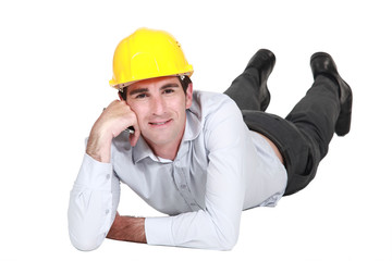 Architect laying on the floor resting