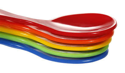 Five colorful plastic spoons