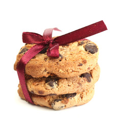 Chocolate chips cookies with red ribbon isolated on white.
