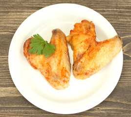 roasted chicken wings with parsley in the plate