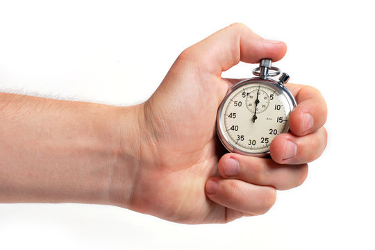 Man's hand holding stopwatch