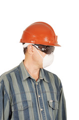 Worker in protective glasses, helmet and respirator
